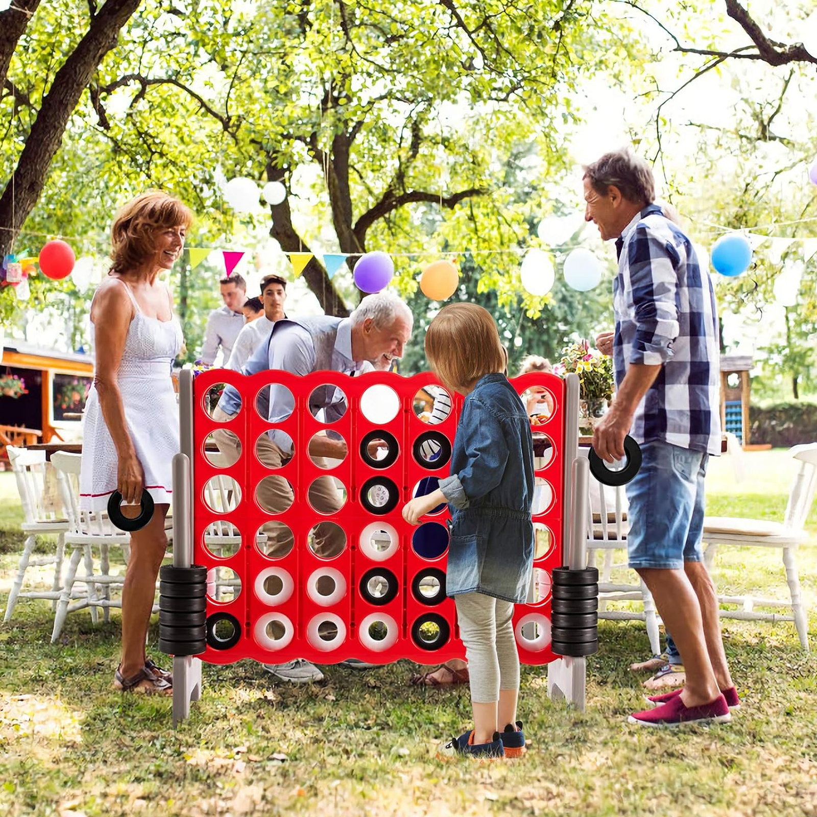 Giant 4-in-A-Row Game for Family Outdoor Parties | Party For Less Rentals Aurora Denver CO Party For Less Rentals giant 4-in-a-row jumbo game multi-generational family playing outdoors Aurora Denver Colorado
